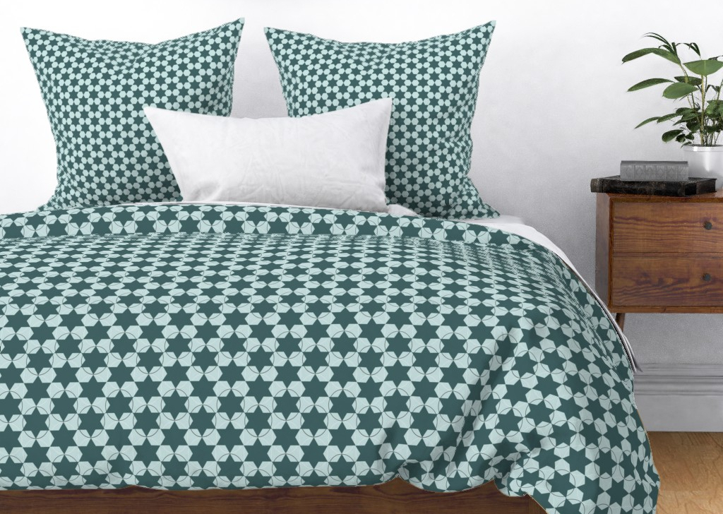 A duvet cover printed with my design Six-Pointed Circled Stars and pillowcases in Small Green Six-Pointed Stars